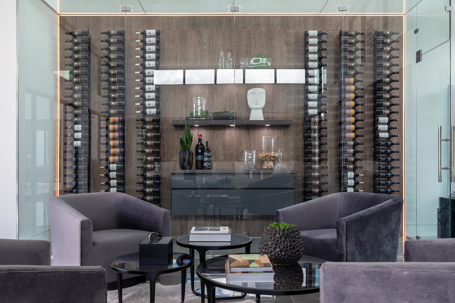 Curved walnut wine cellar with leather chairs